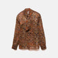 Blusa semitrasparente fantasia con fiocco al collo