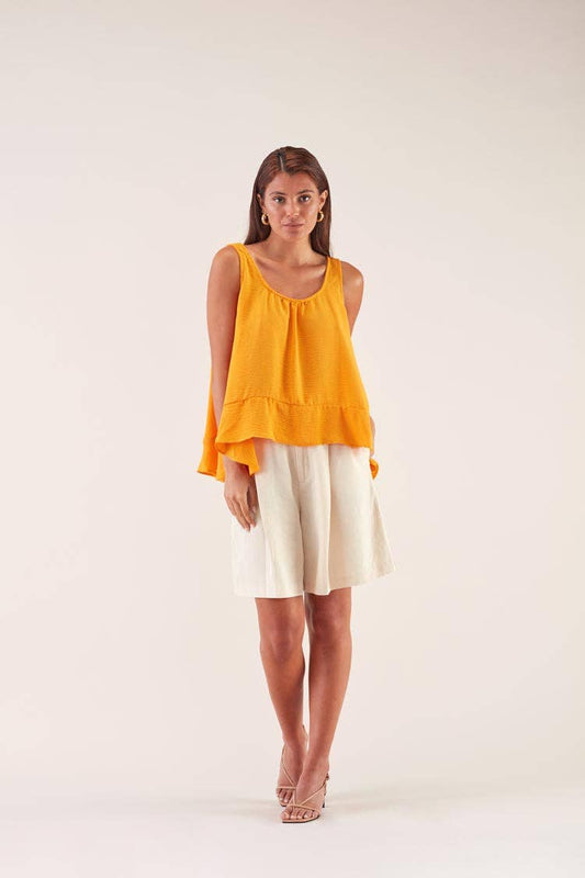 Top lungo svasato arancione con balza