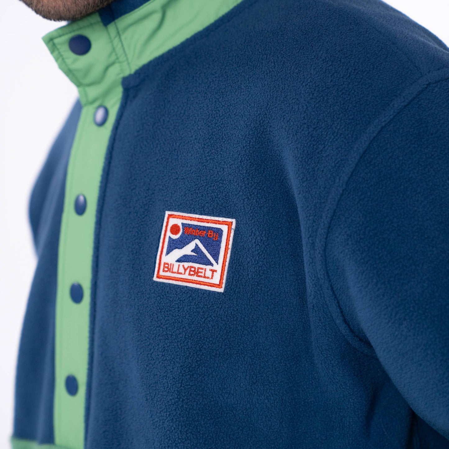 Felpa in pile bicolore blu navy e verde con bottoni