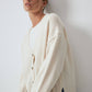 Cardigan in maglia crema con tasche e bottoni