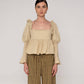 Blusa beige con volant e schiena aperta