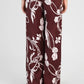 Pantaloni a palazzo bordeaux con stampa floreale