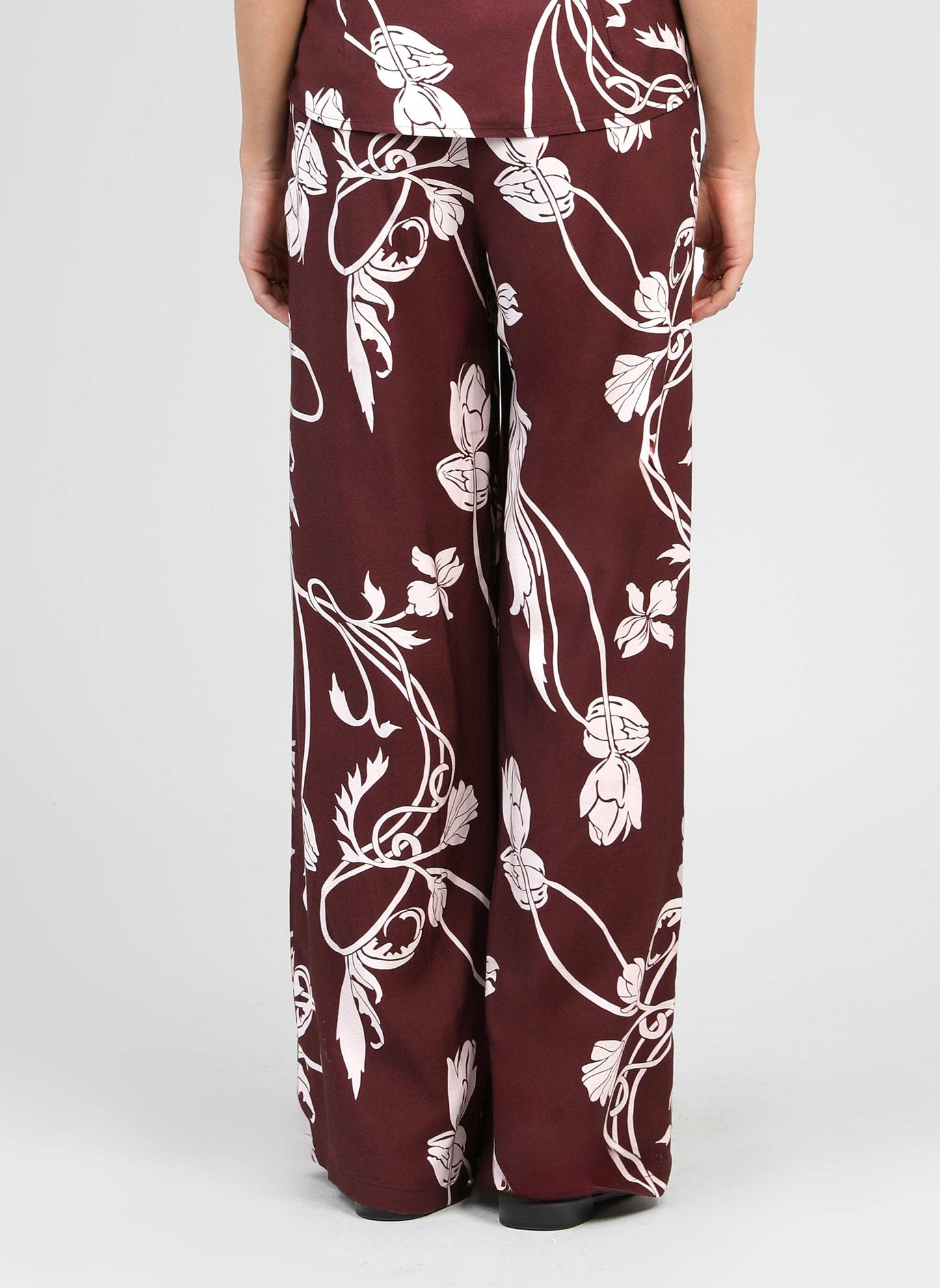 Pantaloni a palazzo bordeaux con stampa floreale