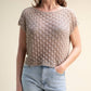 Top corto in crochet traforato dal fit ampio