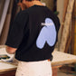 T-shirt oversize nera con stampa spray