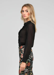 Blusa nera trasparente con volant