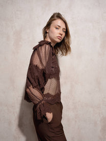 Blusa in pizzo trasparente con collo alto e maniche lunghe
