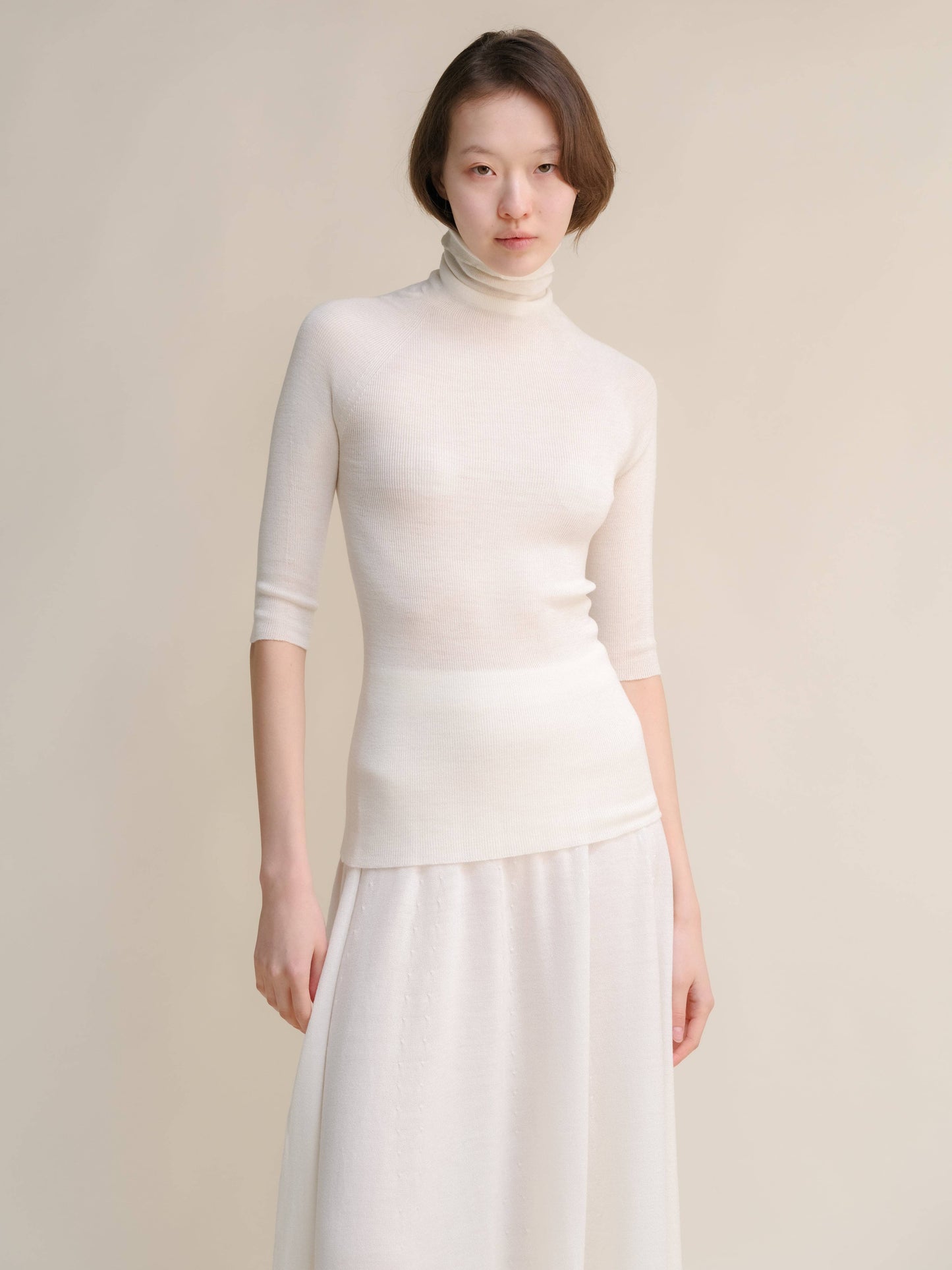 Dolcevita a coste in lana merino extrafine con manica 3/4