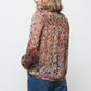 Blusa semitrasparente fantasia con fiocco al collo