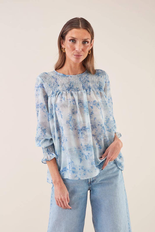 Blusa morbida con elastico e stampa azzurra