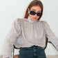 Blusa jacquard con collo alto e maniche a sbuffo