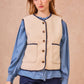 Gilet in ecopelliccia con profili intrecciati blu