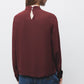 Blusa tinta unita con collo alto
