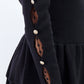 Maglia peplum con inserti in pizzo e bottoni