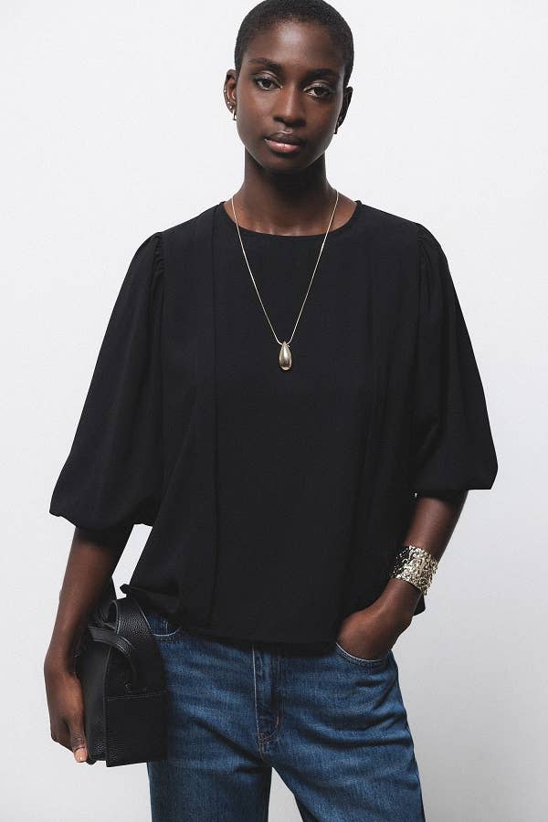 Blusa nera con pieghe e maniche a palloncino