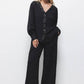 Blusa nera con paillettes e scollo a V