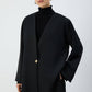 Giacca nera oversize con scollo a V e bottone