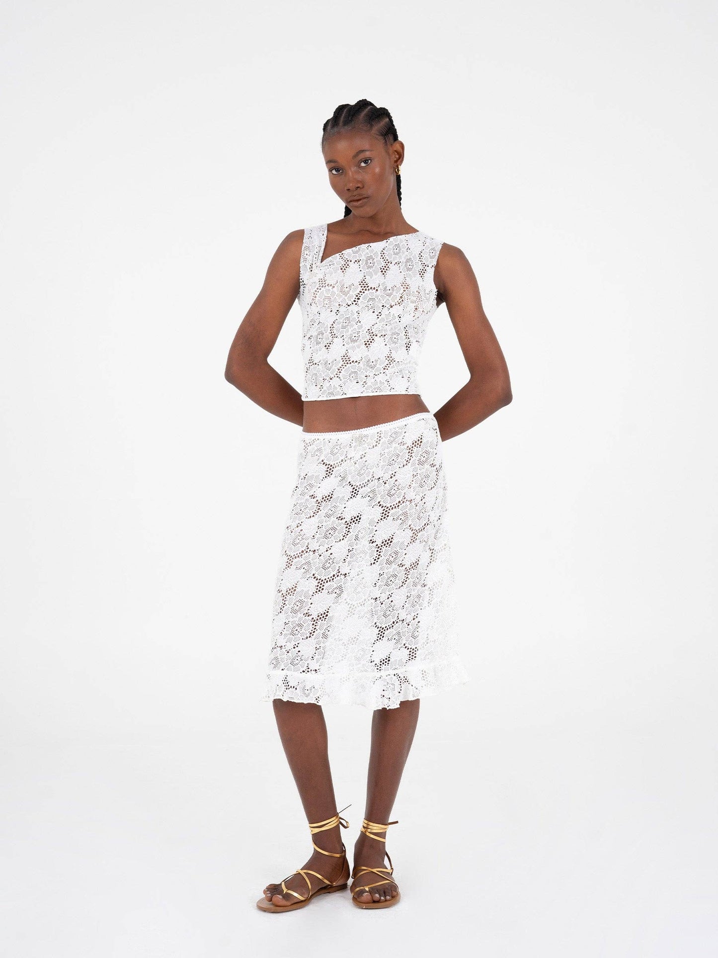 Top asimmetrico in pizzo bianco scintillante