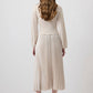 Blusa crema drappeggiata con orlo plissé e maniche a palloncino