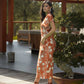 Abito midi terracotta con stampa floreale