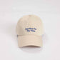 Cappellino beige con ricamo “Just Here For The Vibes”