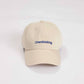 Cappellino beige con ricamo “Overthinking”