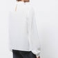 Blusa minimal con collo alto
