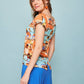 Camicia pareo multicolor con scollo a barca e bottoni sul retro