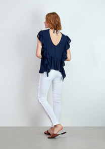 Blusa fluida con volant e schiena a V