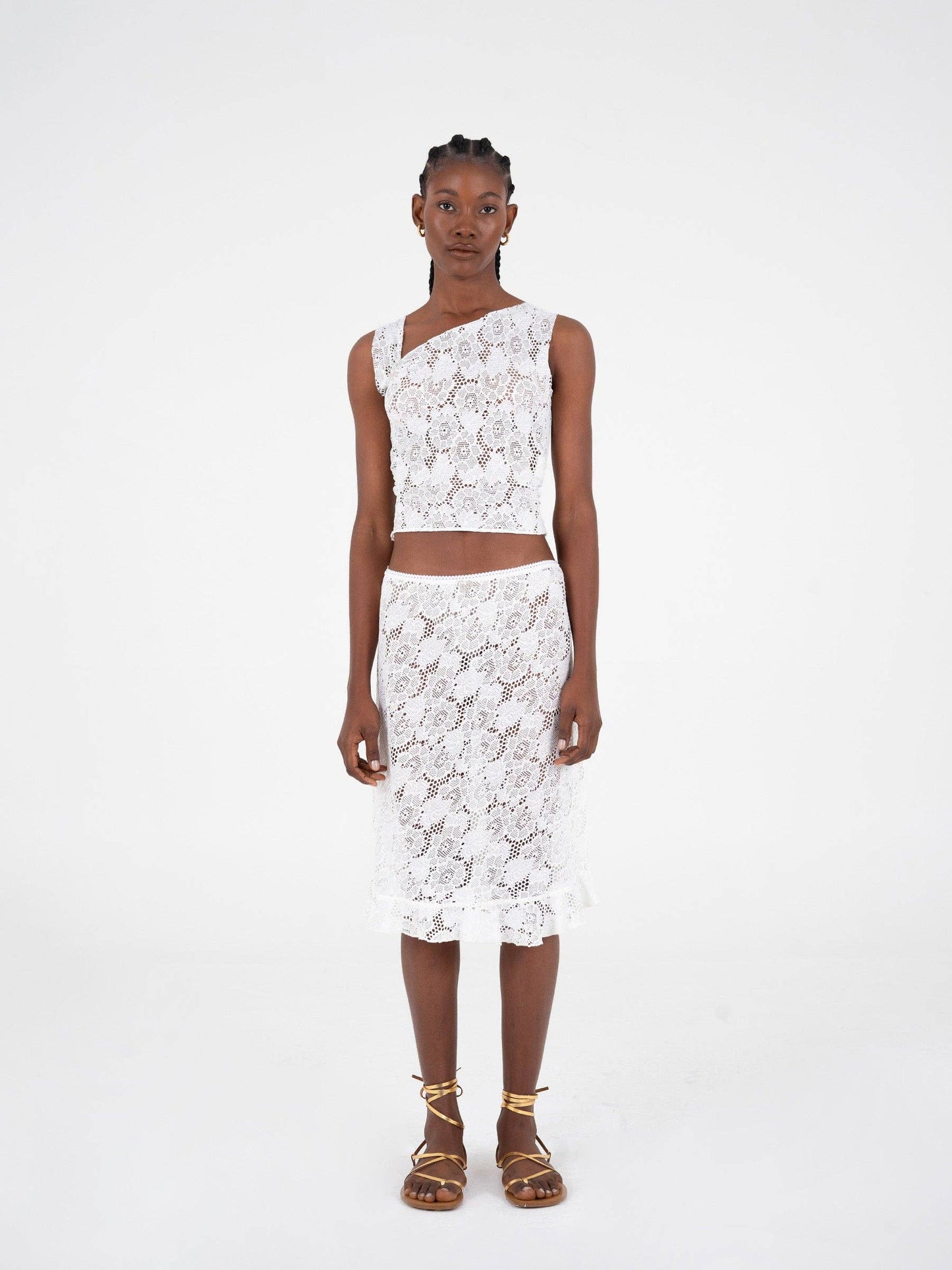 Top asimmetrico in pizzo bianco scintillante