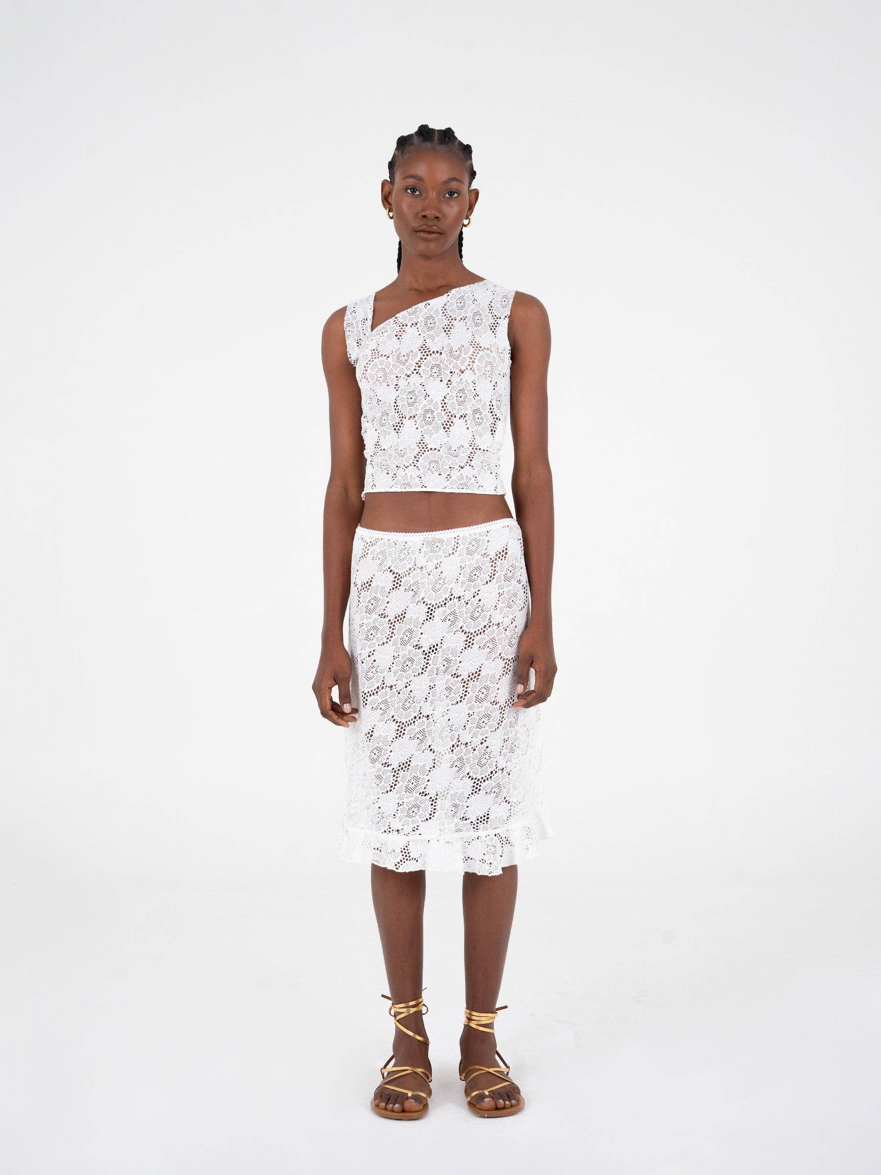 Top asimmetrico in pizzo bianco scintillante