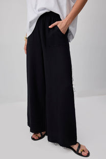 Pantaloni palazzo in cotone con dettagli sfrangiati
