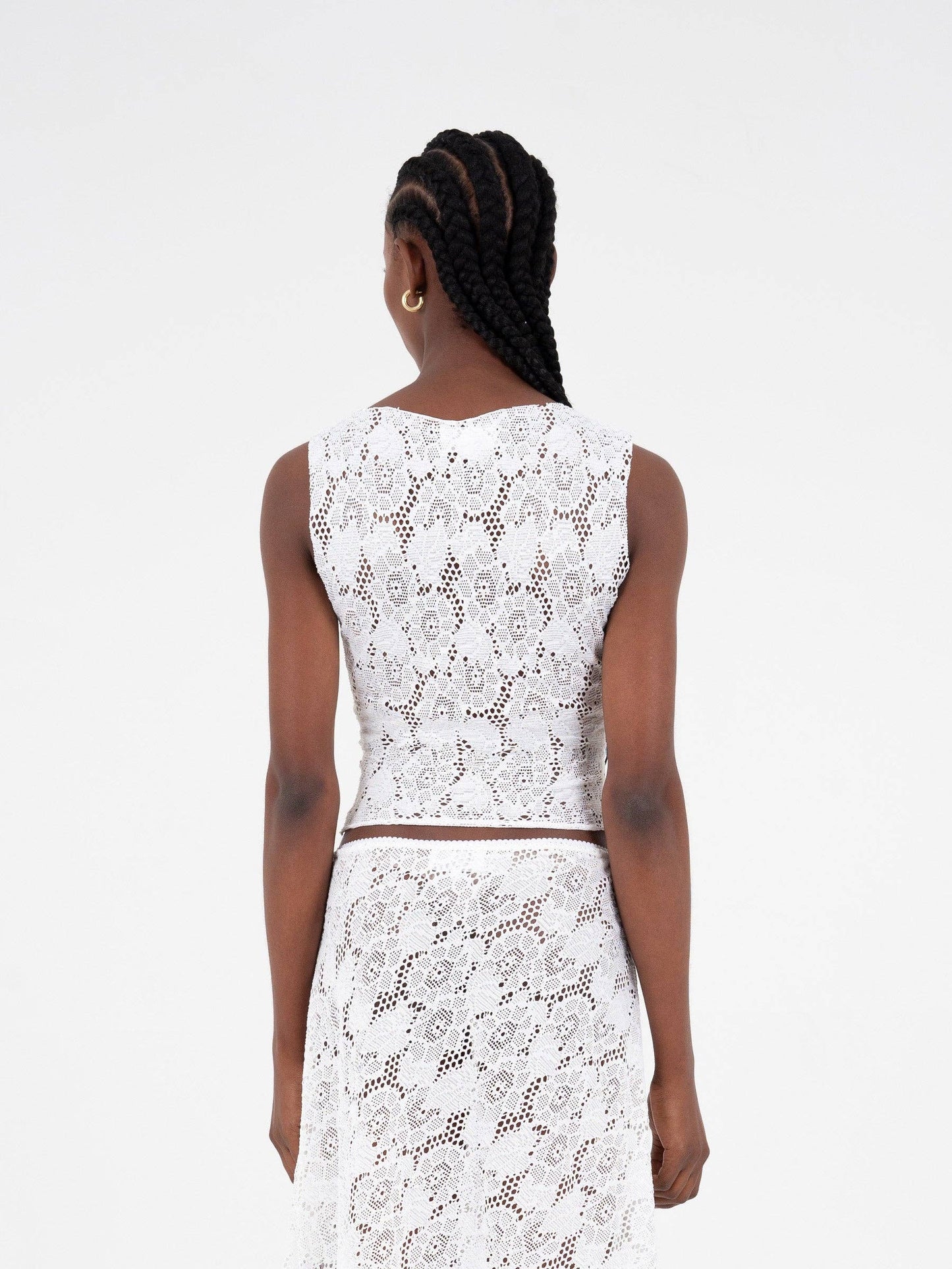 Top asimmetrico in pizzo bianco scintillante