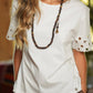 T-shirt in cotone con maniche ricamate