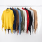 Poncho in maglia con frange e collo alto