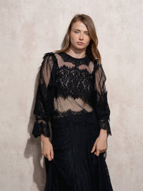 Blusa in pizzo trasparente con collo alto e maniche lunghe