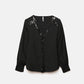 Blusa nera con paillettes e scollo a V