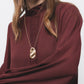 Blusa tinta unita con collo alto