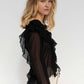 Blusa nera semitrasparente con volant