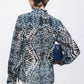 Blusa stampata con fiocco al collo