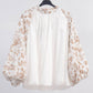 Blusa floreale con maniche a sbuffo