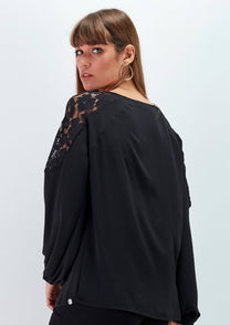 Blusa nera con inserti in pizzo e laccio al collo