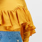 Blusa gialla con balze e pieghe sul petto