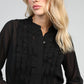 Blusa nera trasparente con volant