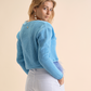 Cardigan in tricot con piume
