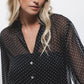 Blusa a pois semitrasparente con scollo a V