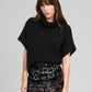 Pull oversize nero stile poncho con collo alto