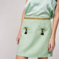 Gonna corta in tweed a quadri con cintura dorata