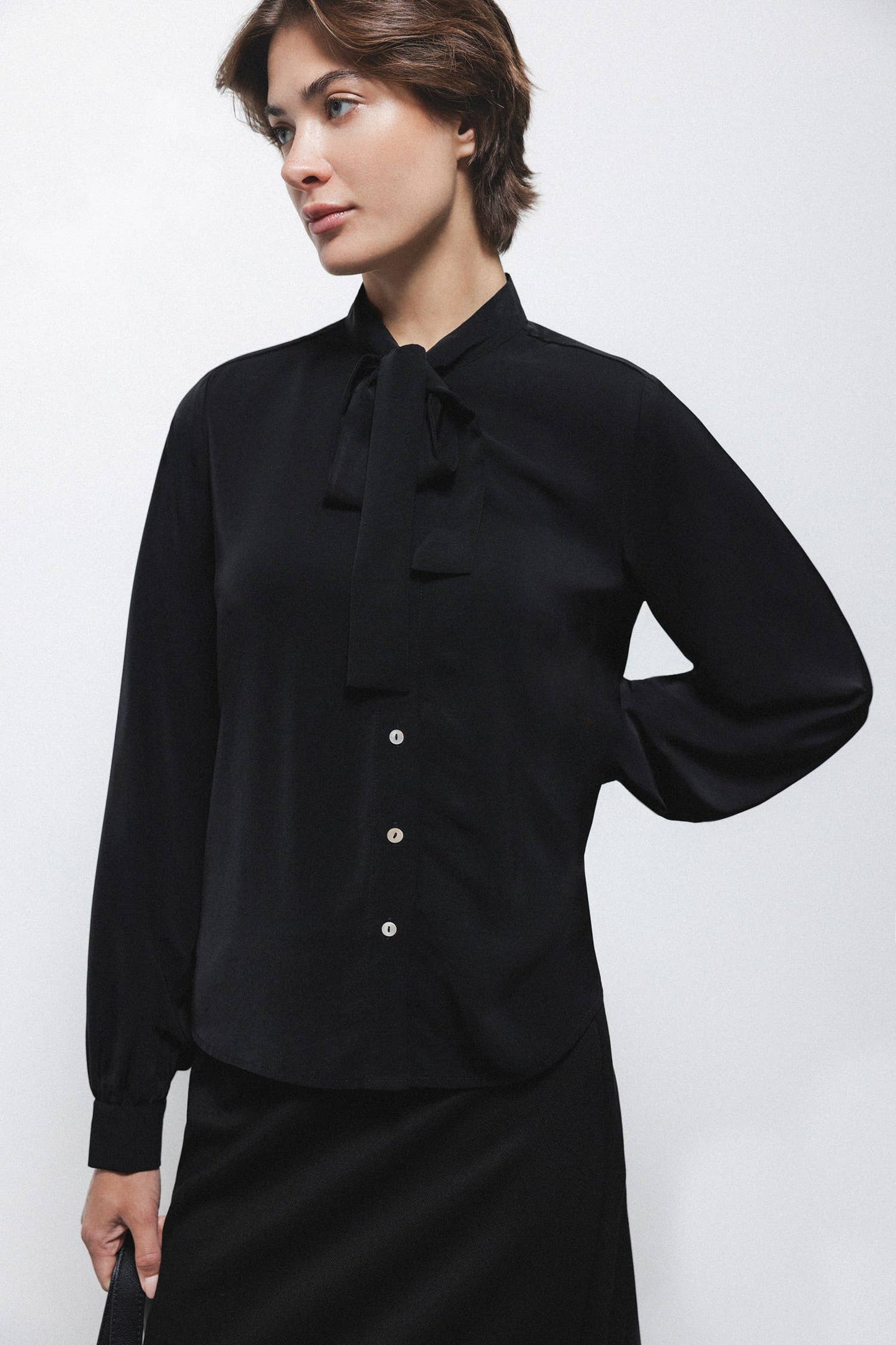 Blusa nera con fiocco al collo