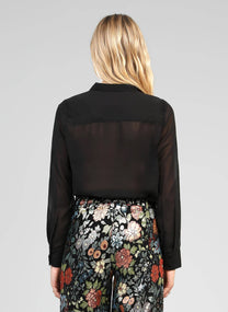 Blusa nera trasparente con volant